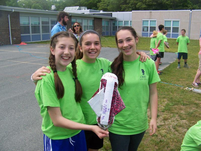 From left, Emily Kirkham, Morgan Roy and Amanda Rapoza show off their rocket, "The Moon." BY MATTHEW BERNAT